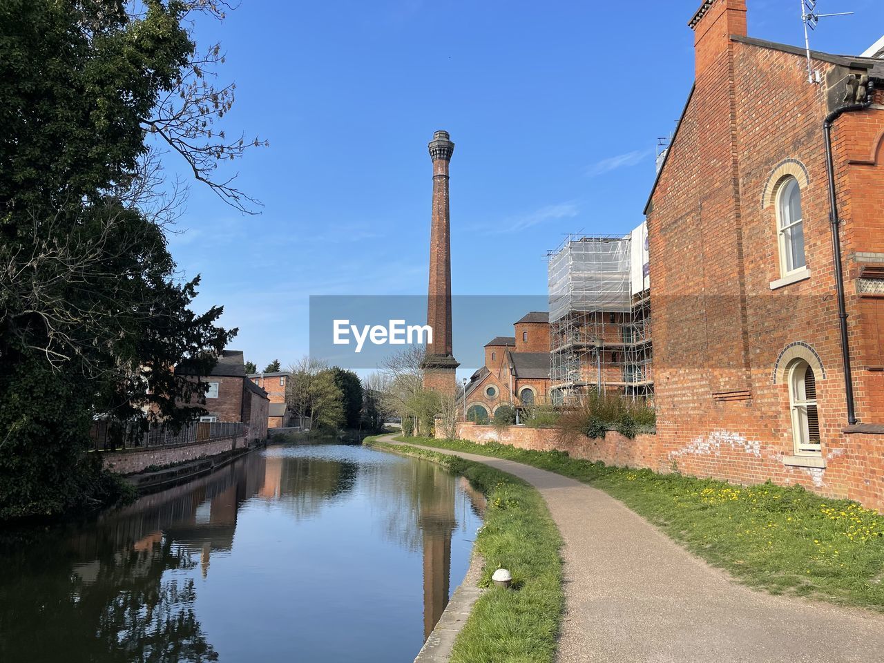 REFLECTION OF BUILDINGS AND TREES IN CANAL