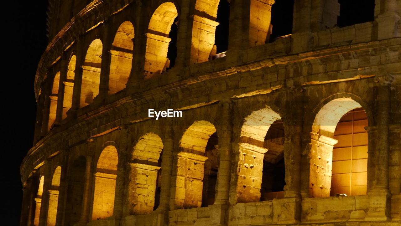 Low angle view of coliseum at night