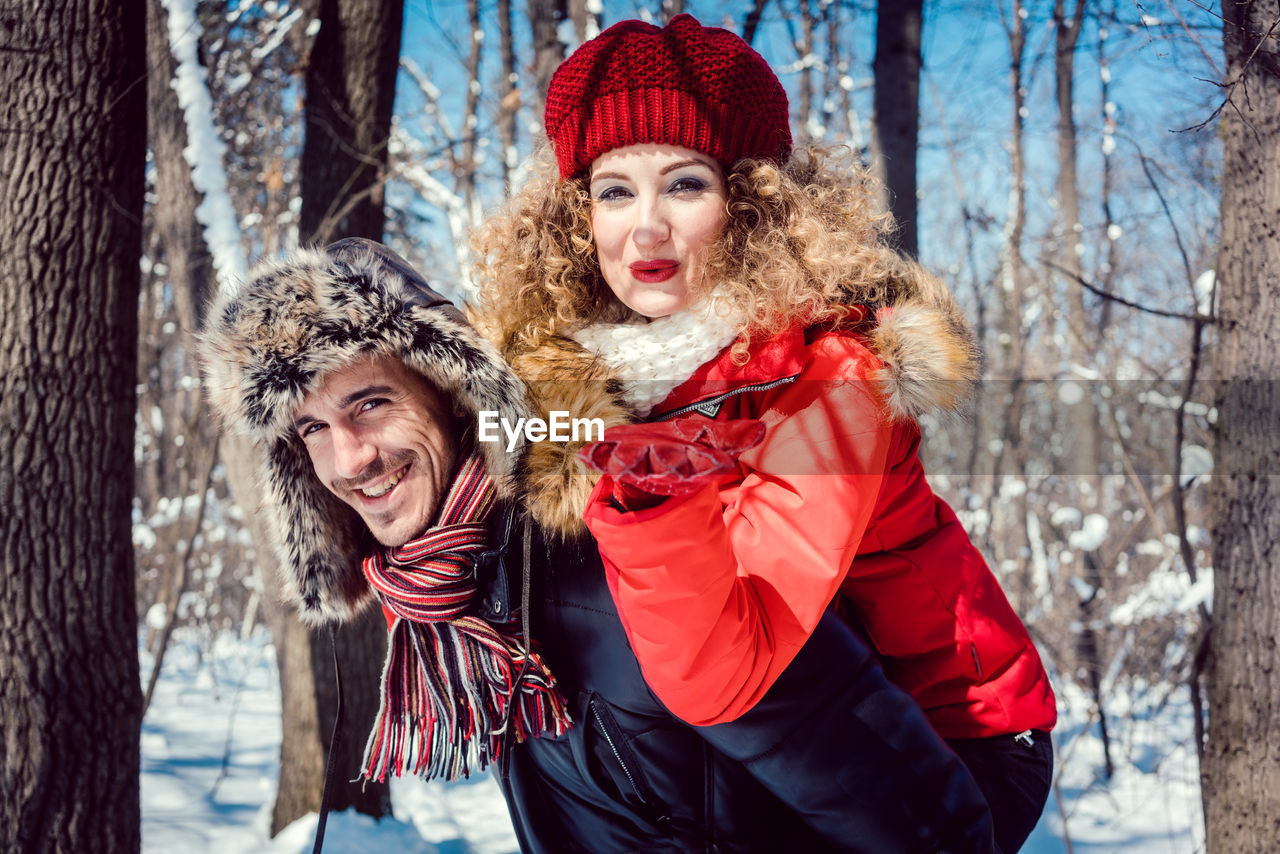 Portrait of smiling couple against trees