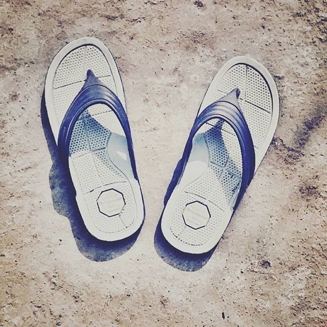 PAIR OF SHOES ON TILED FLOOR