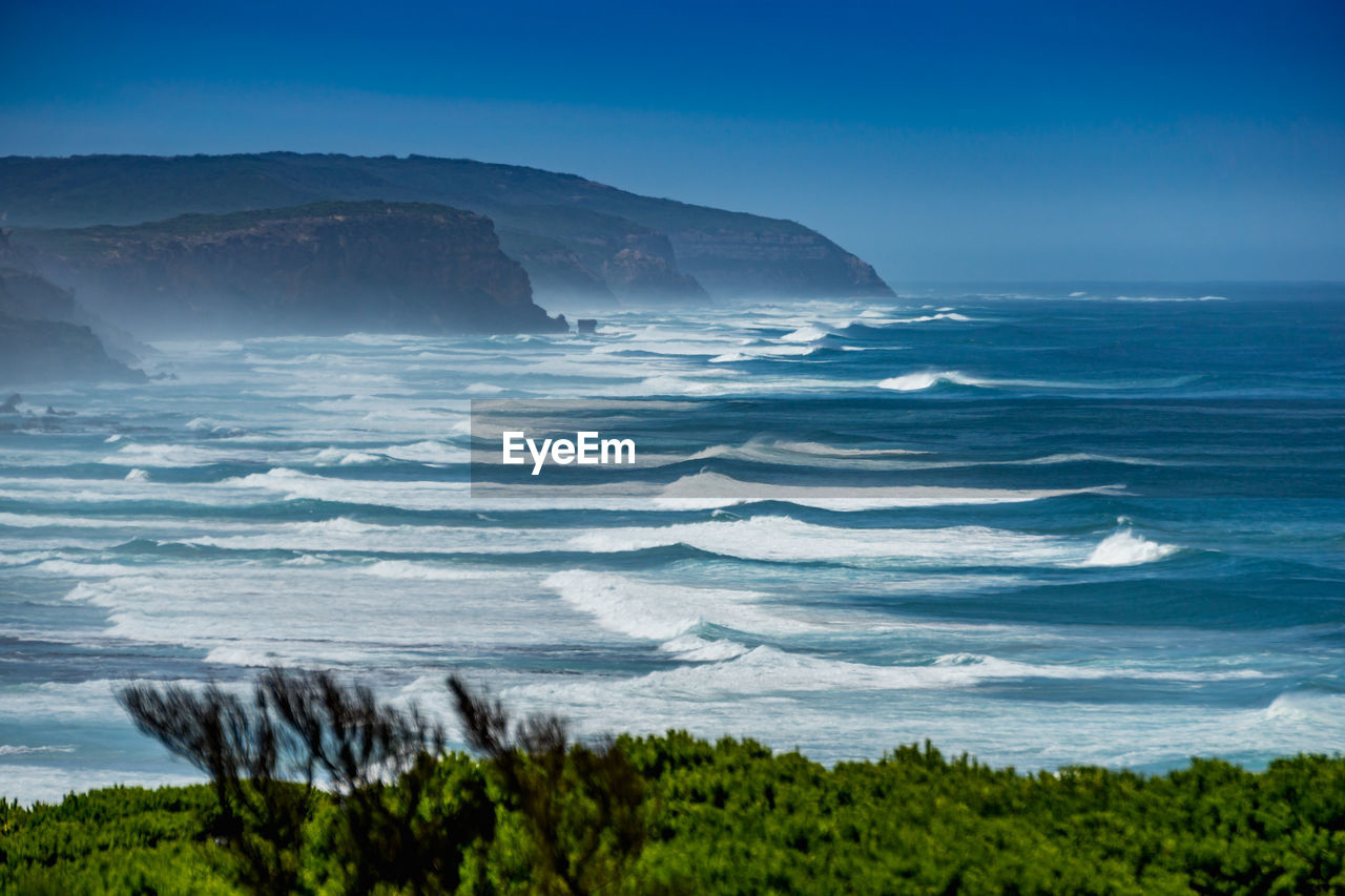 Scenic view of sea against blue sky