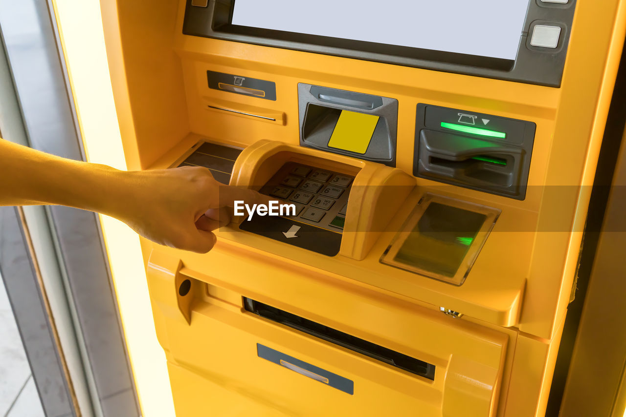 Cropped hand using atm