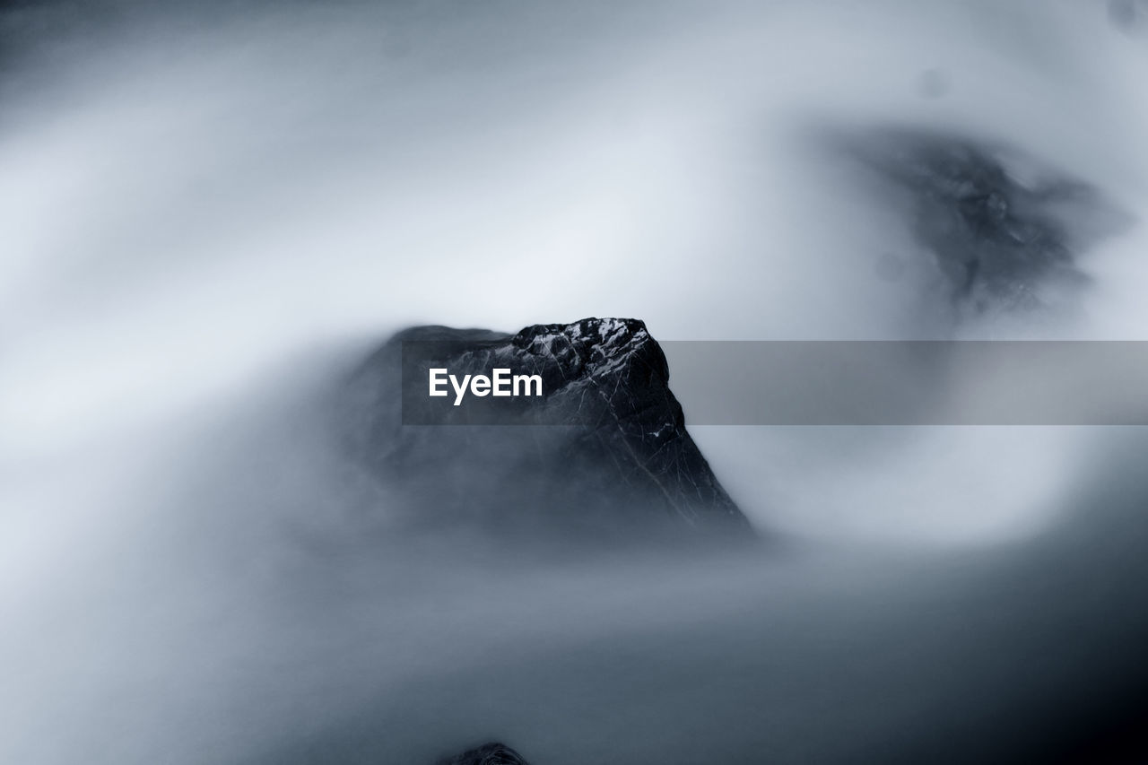 Aerial view of mountain peak in foggy weather