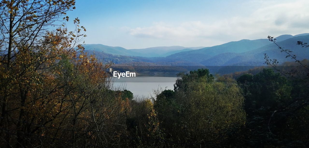 Scenic view of lake and mountains against sky