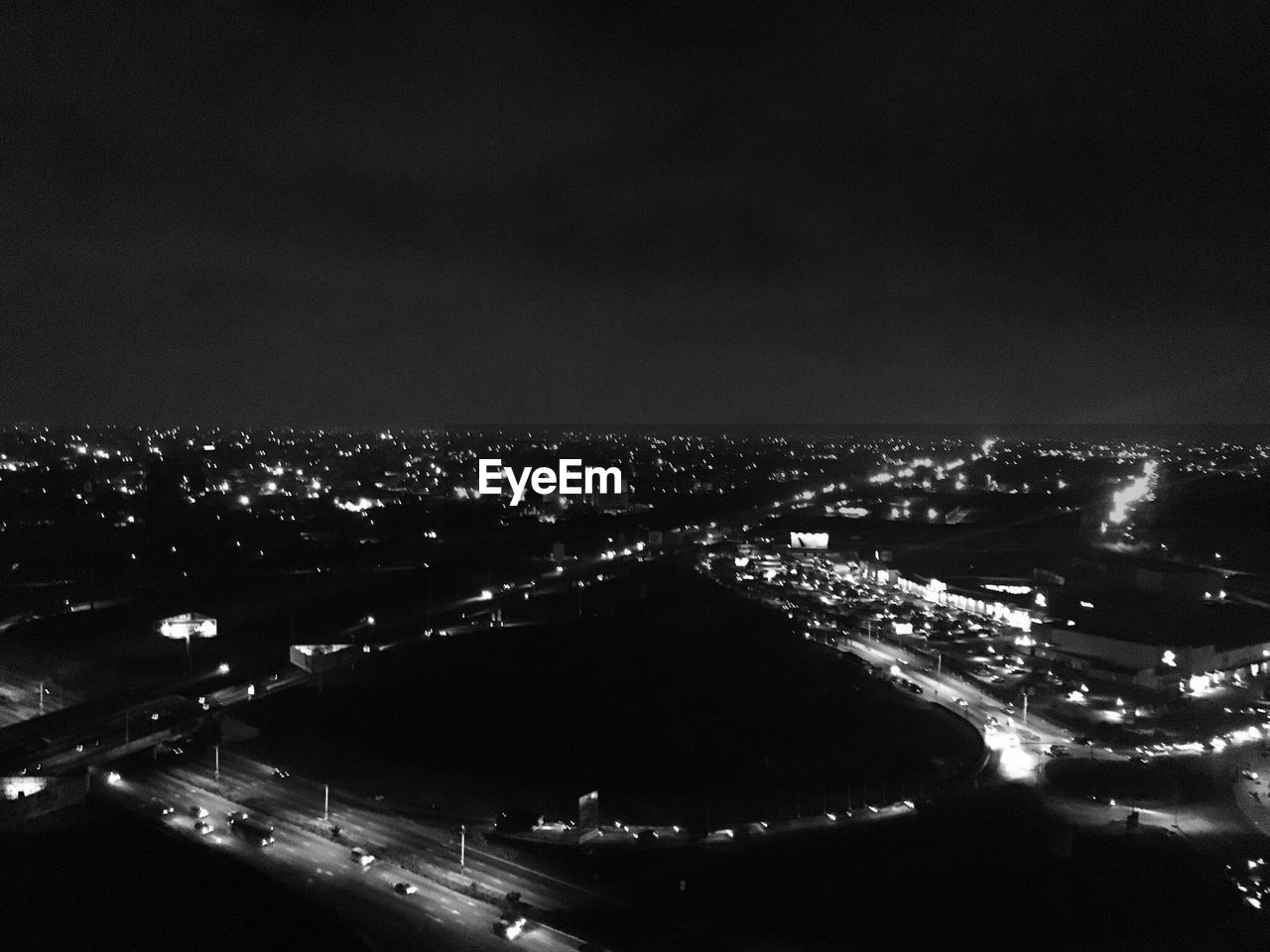 AERIAL VIEW OF ILLUMINATED CITYSCAPE AT NIGHT