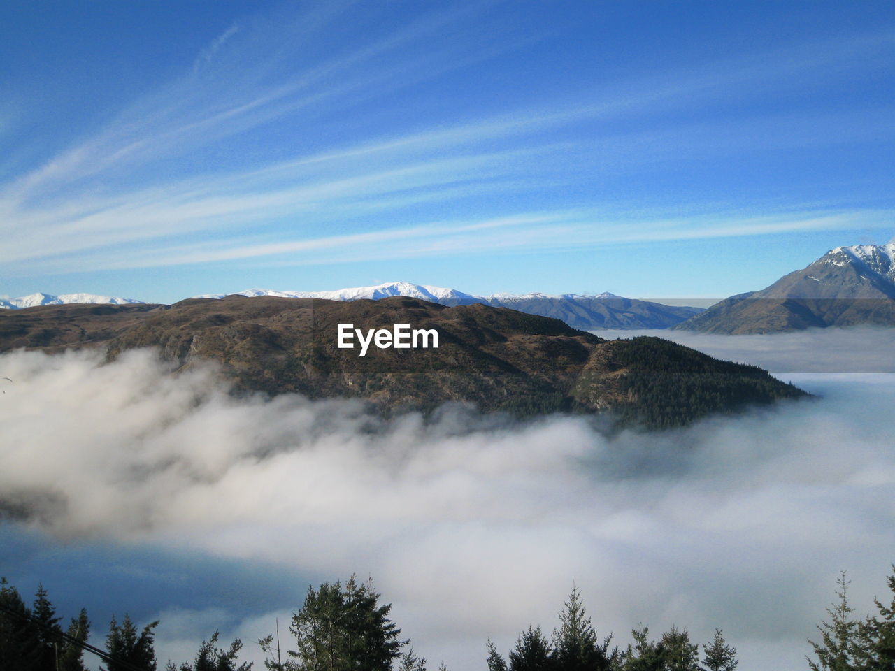 Scenic view of mountains against cloudy sky