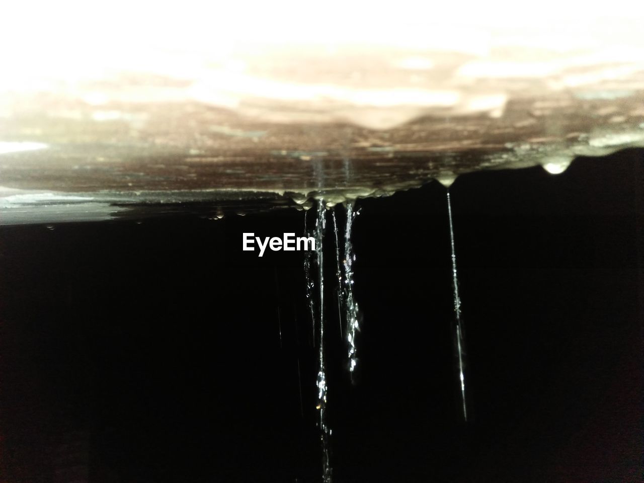 CLOSE-UP OF FROZEN WATER ON ROOF AGAINST CLEAR SKY