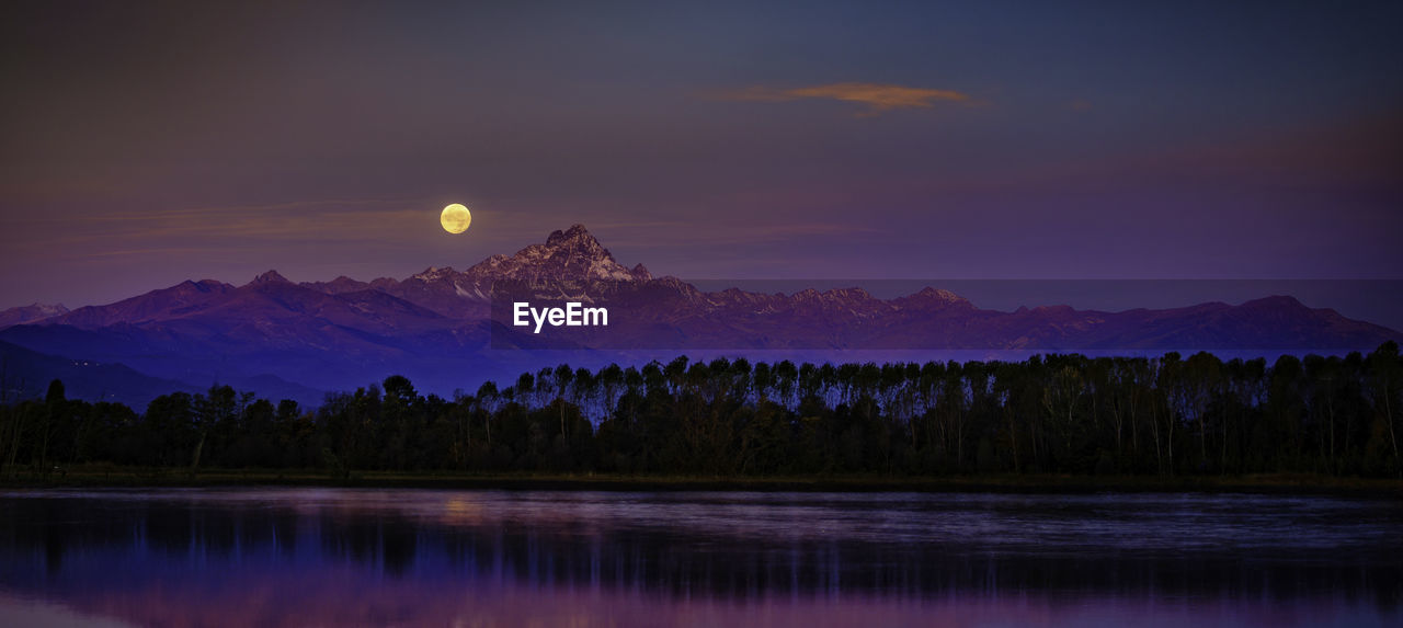 Lunar sunset behind the mountain in italy