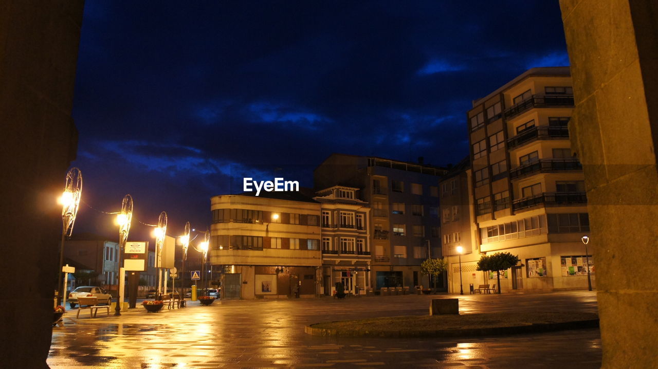 BUILDINGS IN CITY AT NIGHT