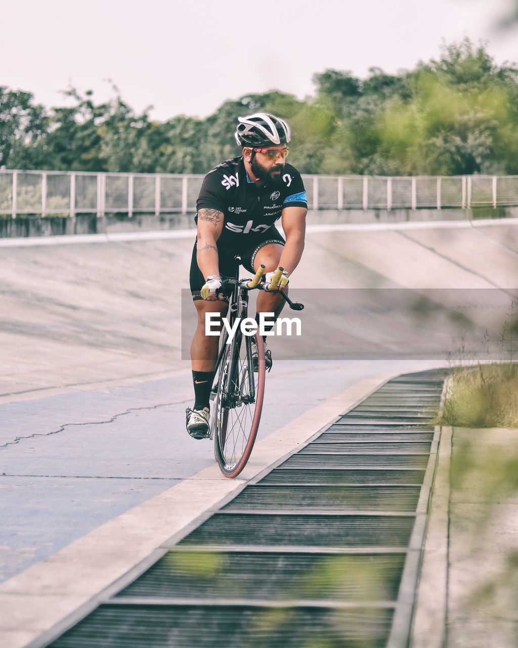 FULL LENGTH OF MAN RIDING BICYCLE ON STREET