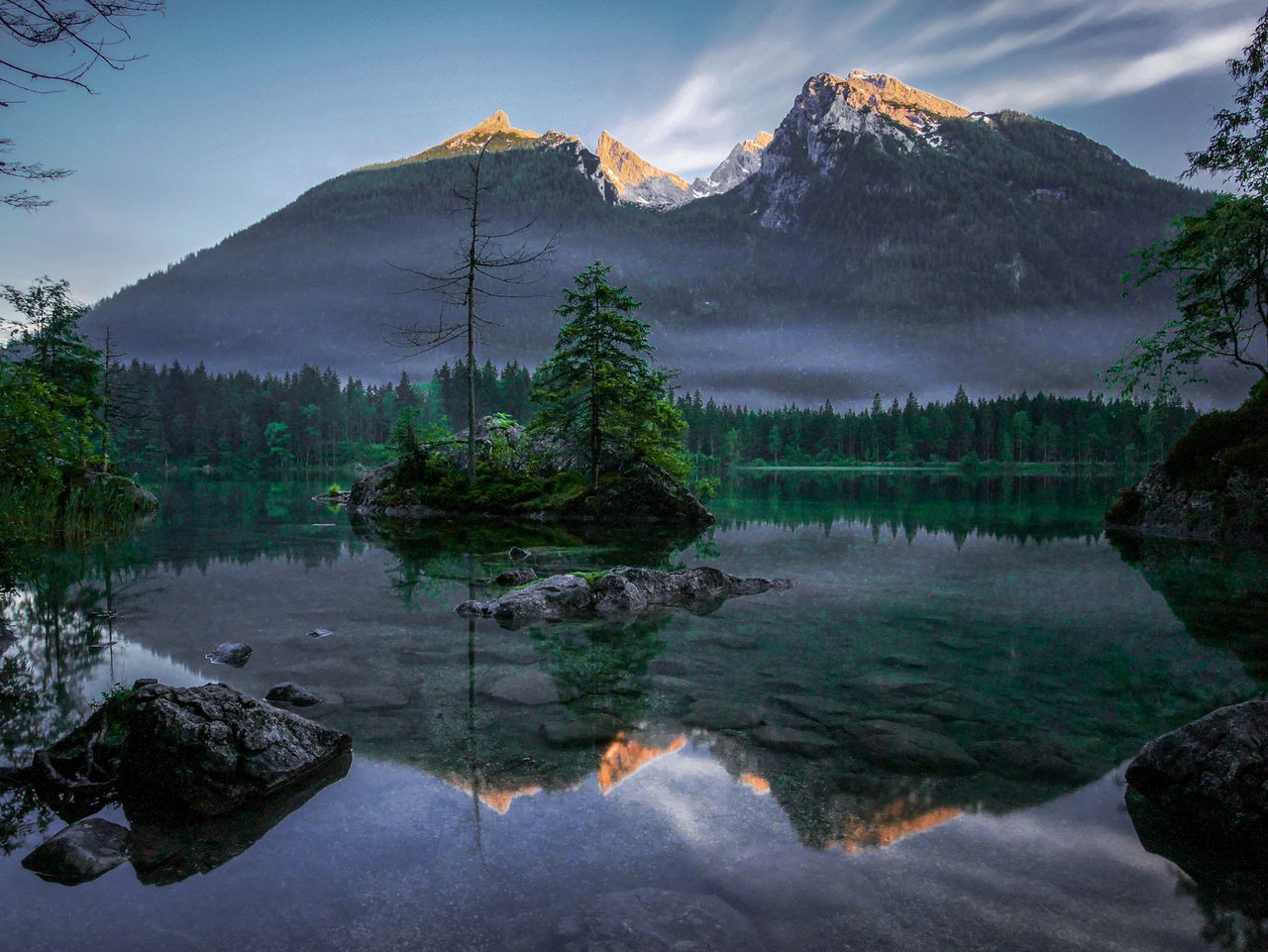 Scenic view of lake and mountains against sky