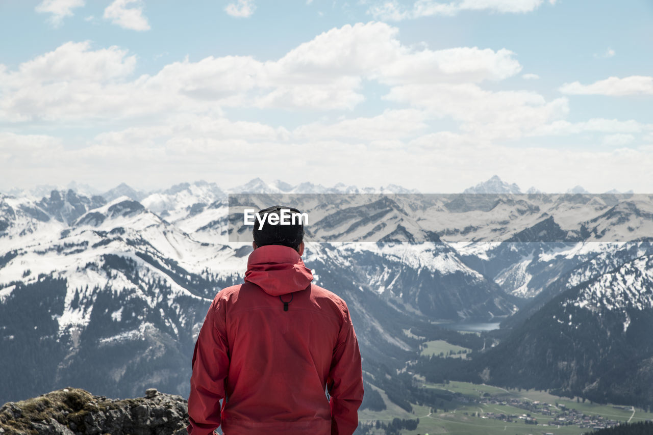 Rear view of man against european alps