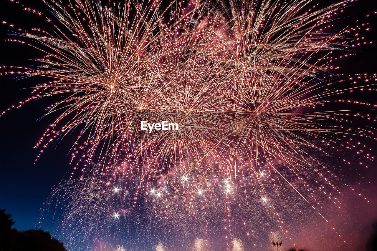 Low angle view of colorful firework display at night