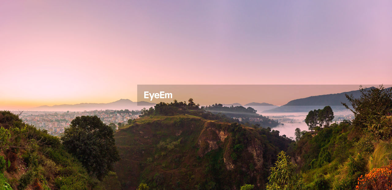 Scenic view of mountains against sky at sunset