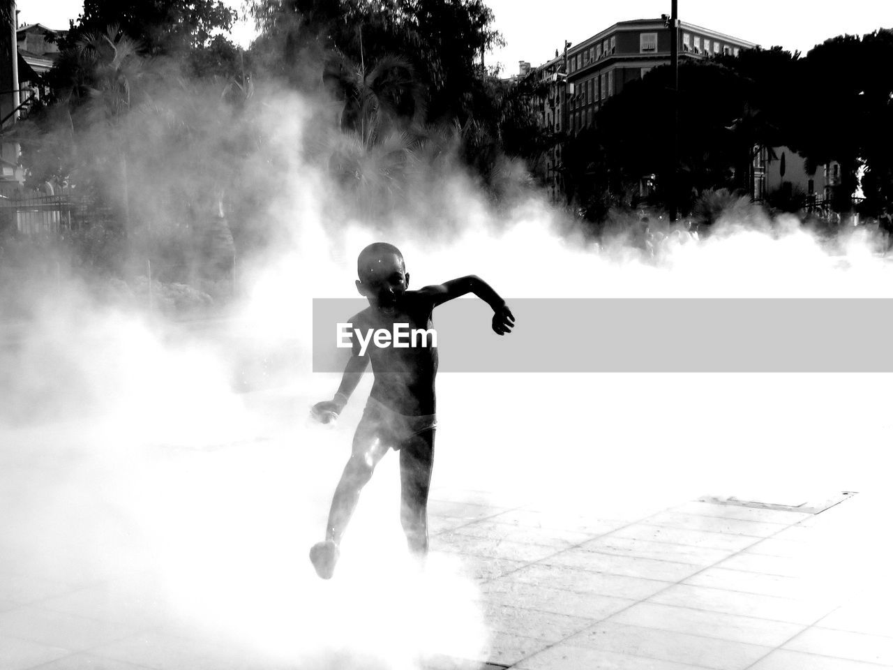 Full length of boy playing in smoke