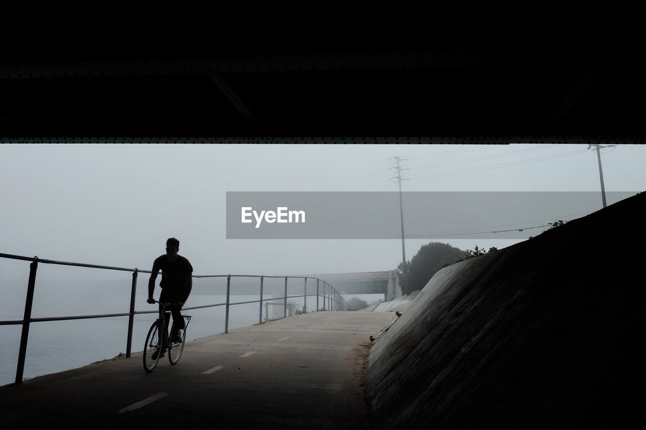 Man riding bicycle on road