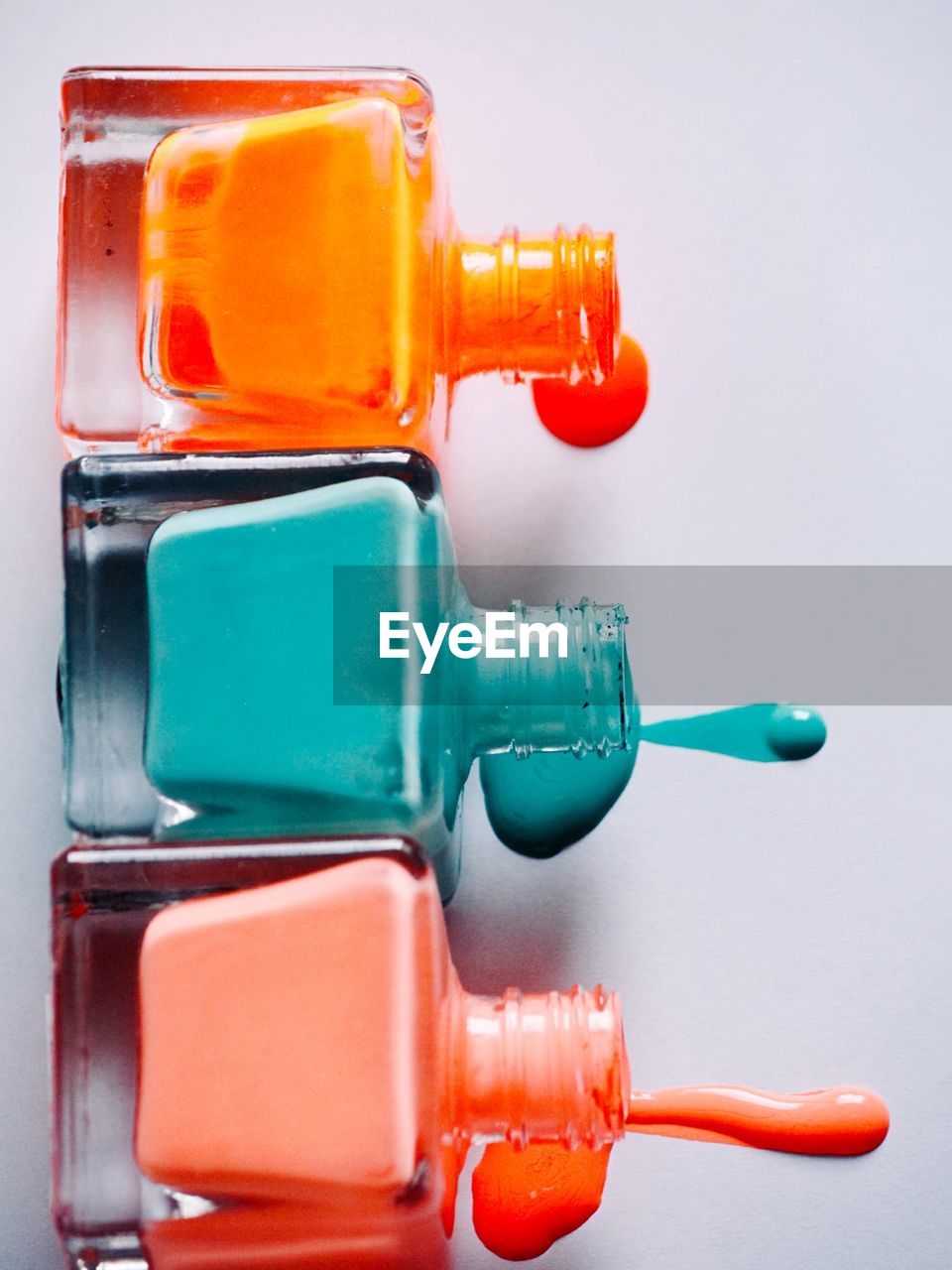 CLOSE-UP OF MULTI COLORED BOTTLE ON TABLE