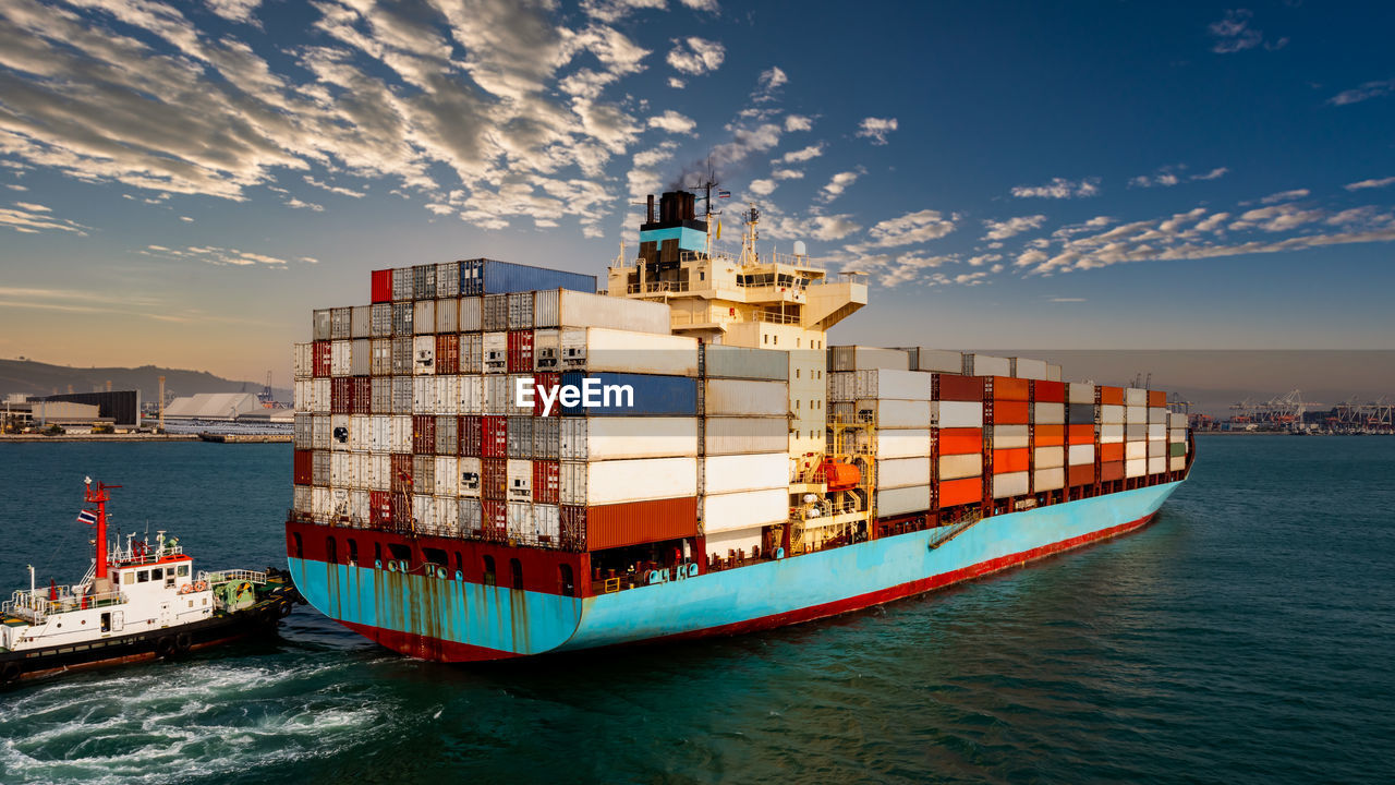 Container cargo ship carrying commercial container in import export business 