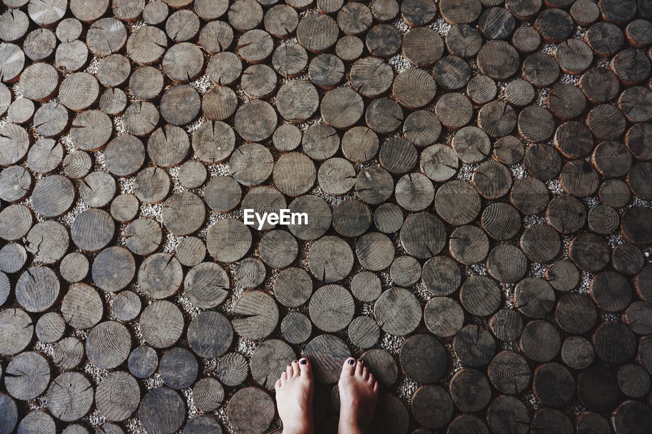 Low section of woman on wooden floor