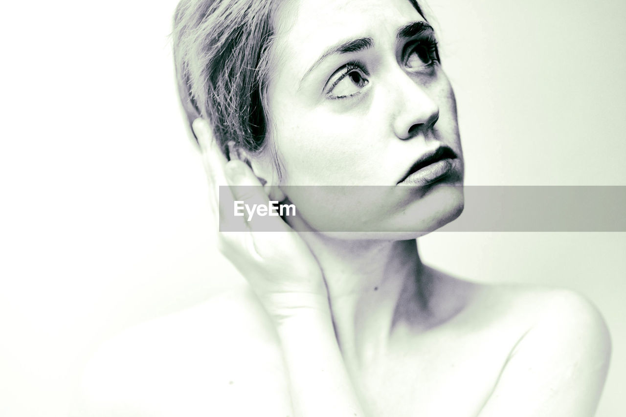 Close-up of woman against white background