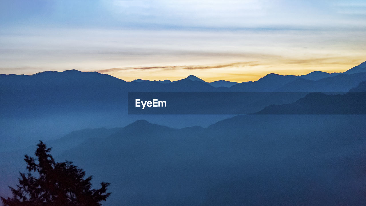 Scenic view of mountains against sky during sunset