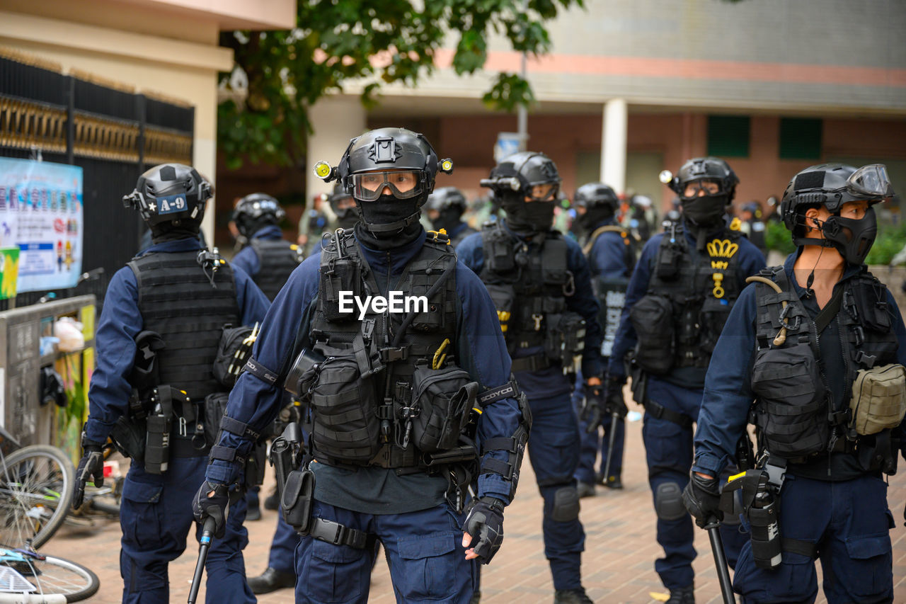 Police force standing on street