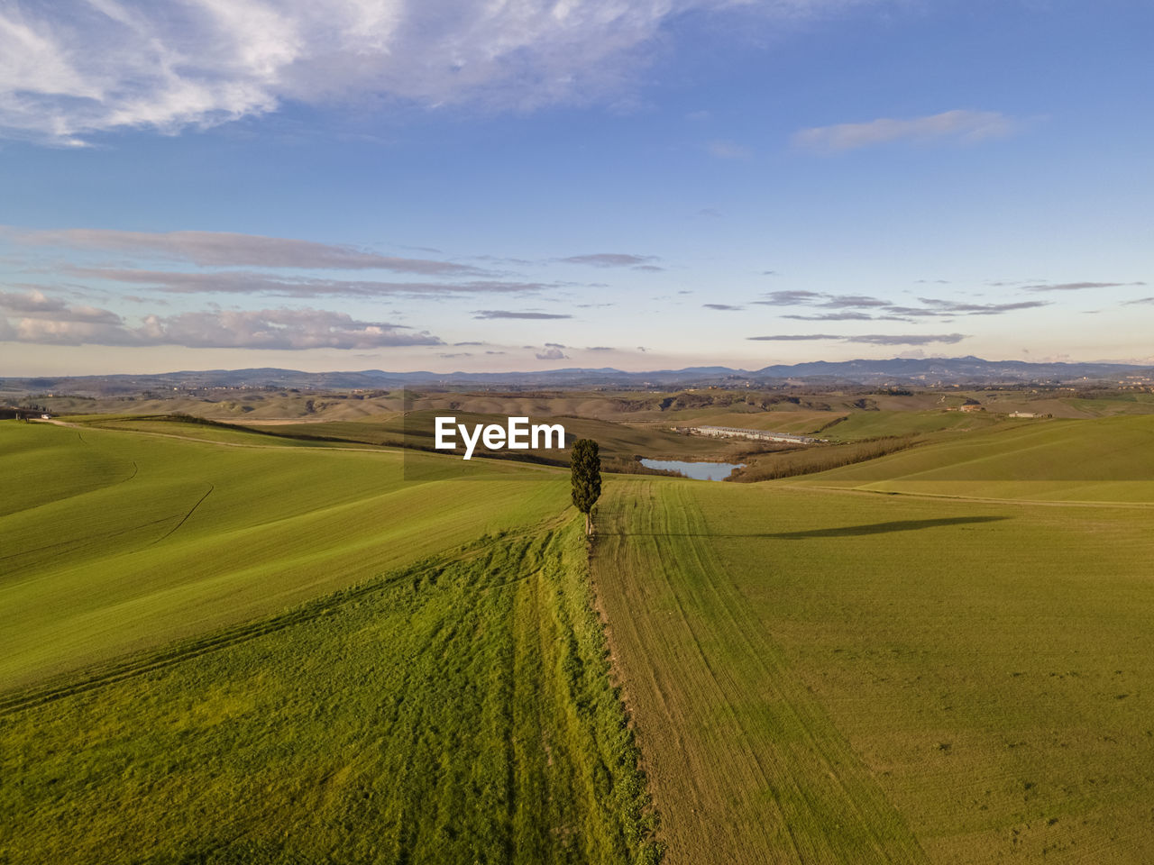 SCENIC VIEW OF FARMS AGAINST SKY