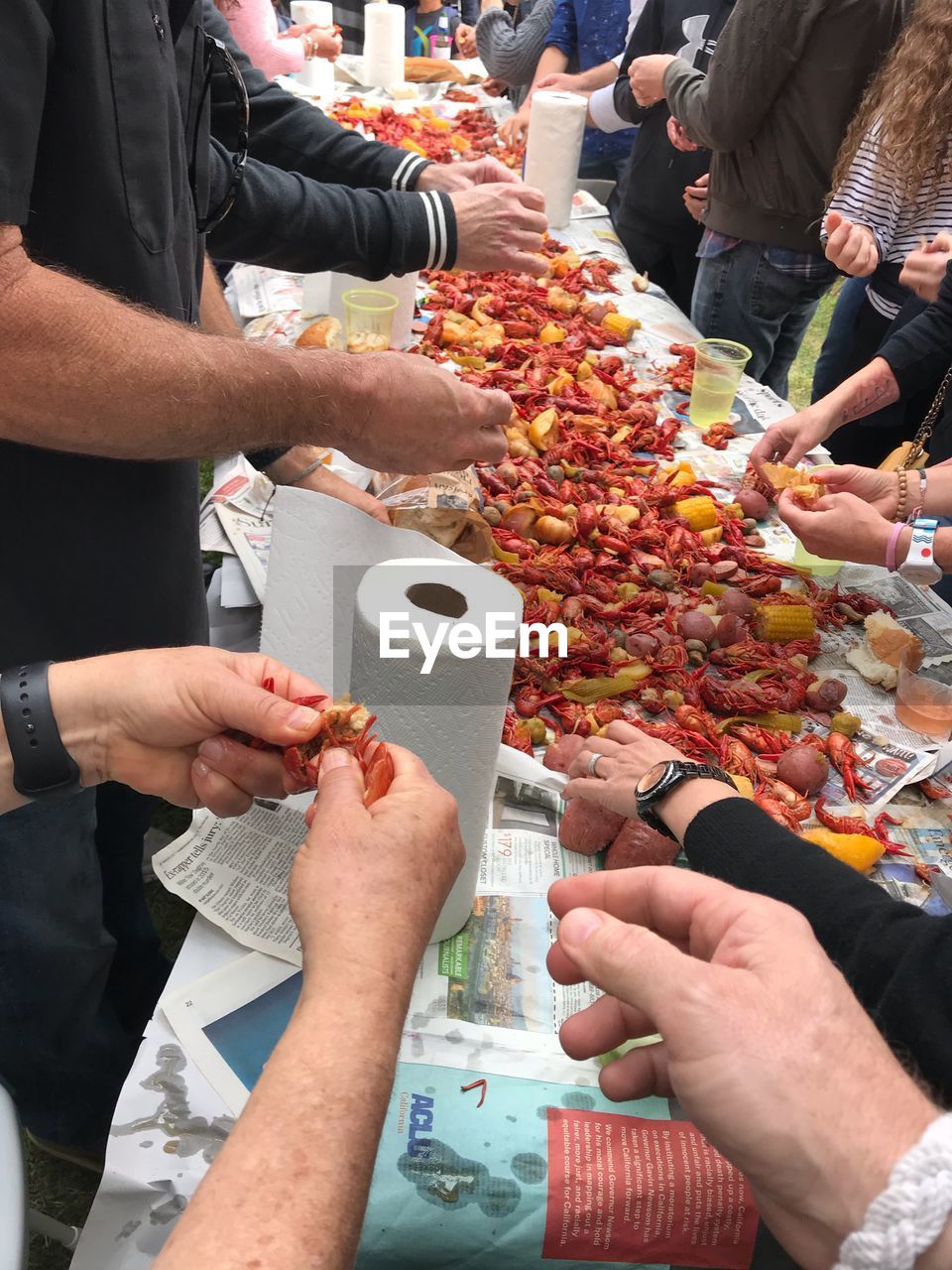 HIGH ANGLE VIEW OF PEOPLE HOLDING ICE CREAM AT MARKET