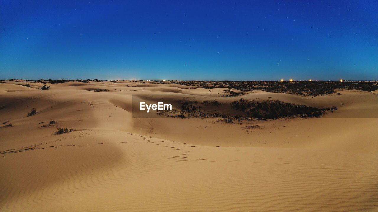 View of desert against blue sky