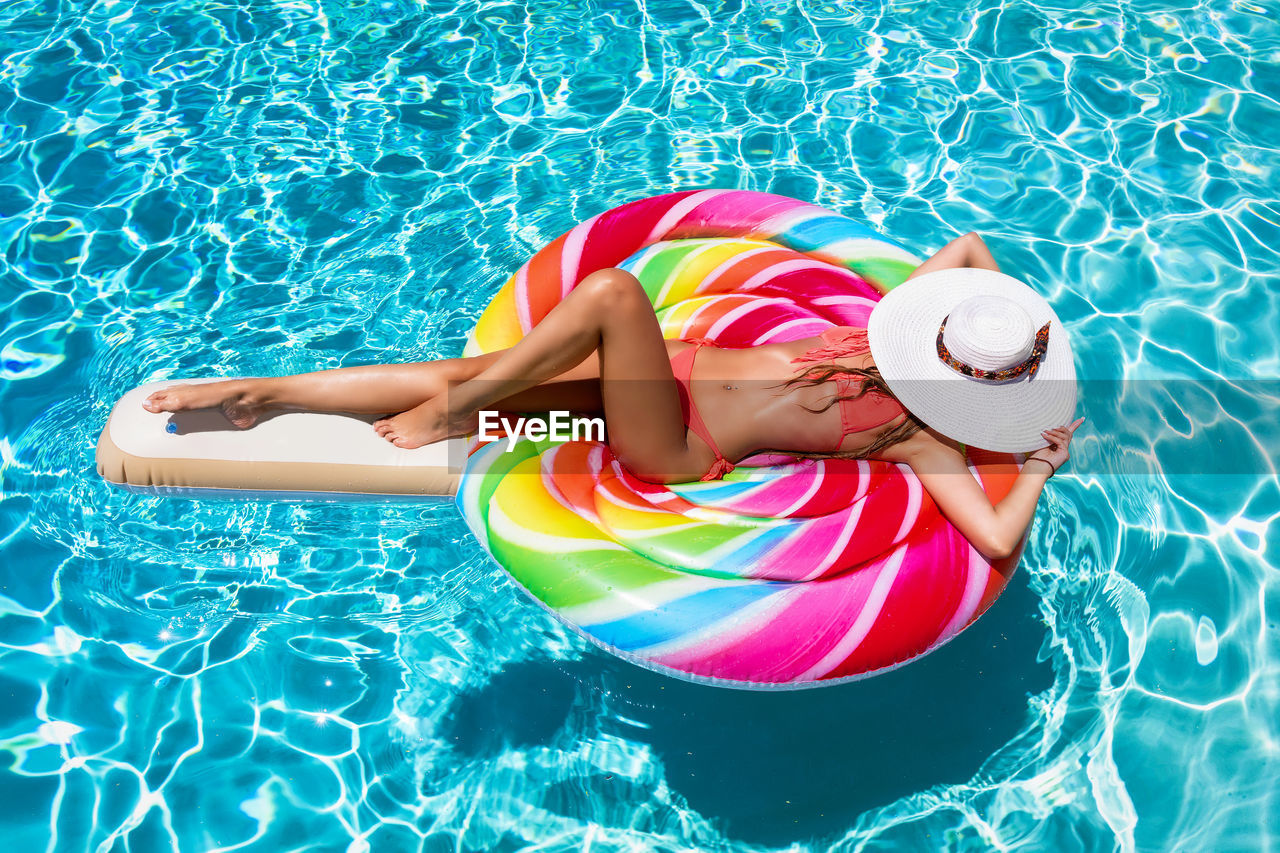 HIGH ANGLE VIEW OF BOY IN SWIMMING POOL