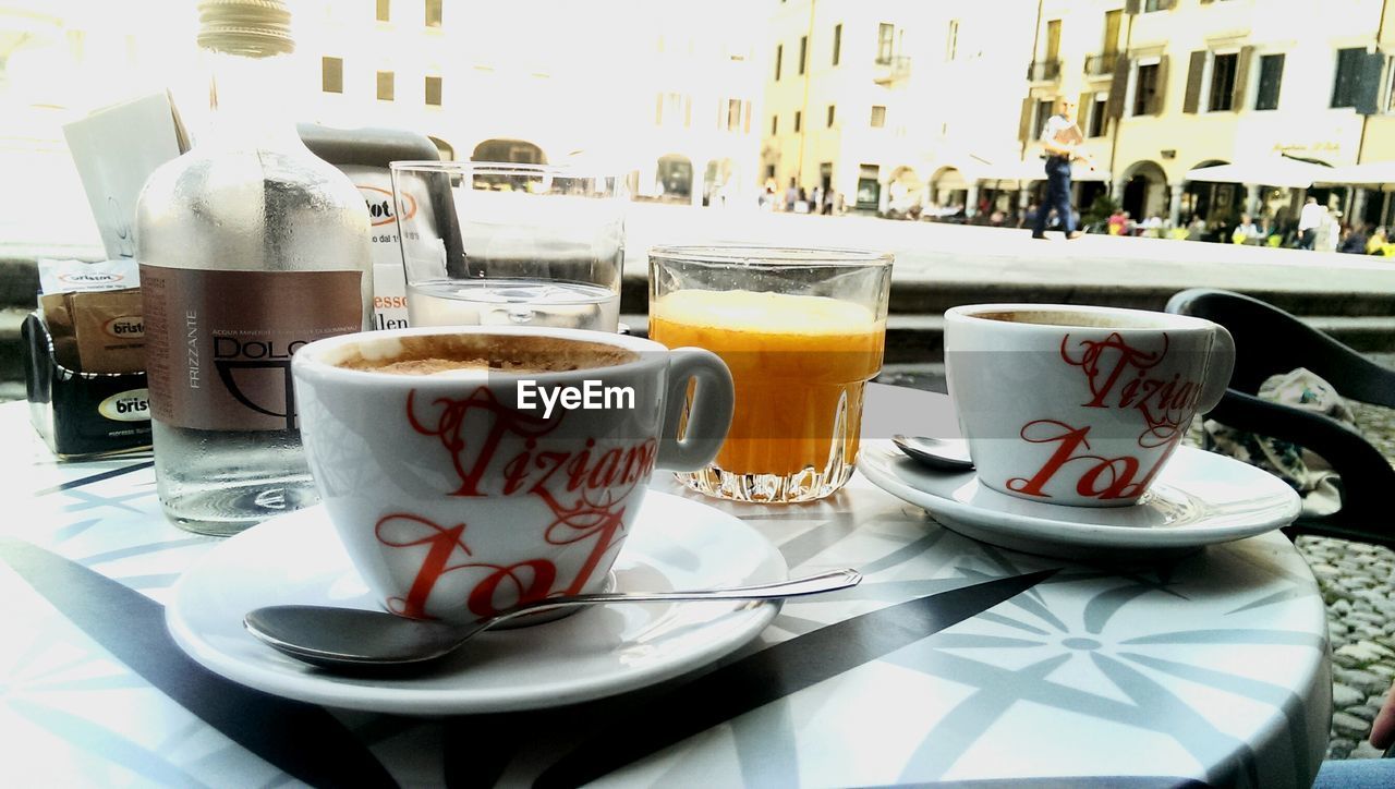 COFFEE CUP WITH COFFEE CUP ON TABLE