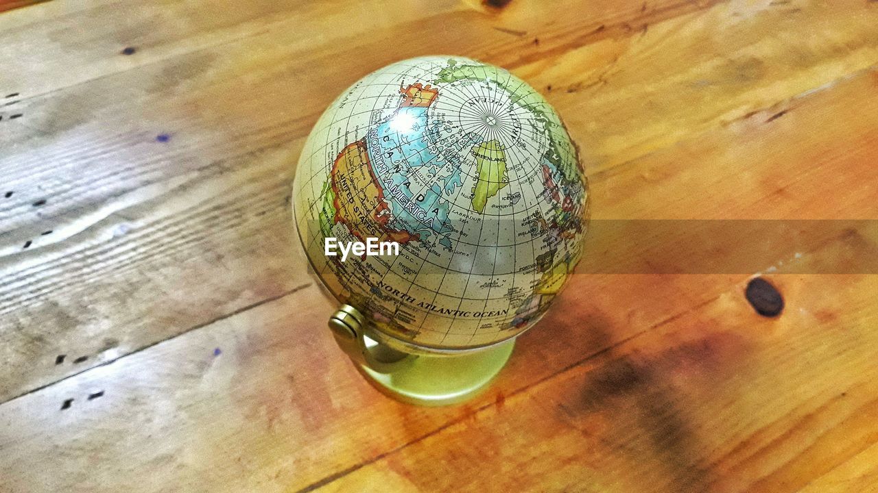 High angle view of globe on wooden table