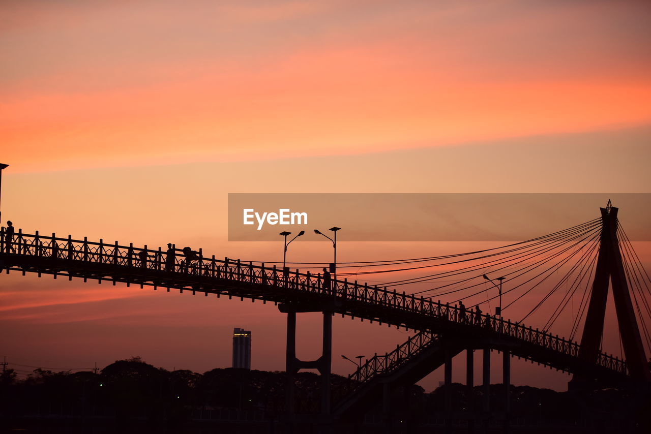 Silhouette bridge against sky during sunset