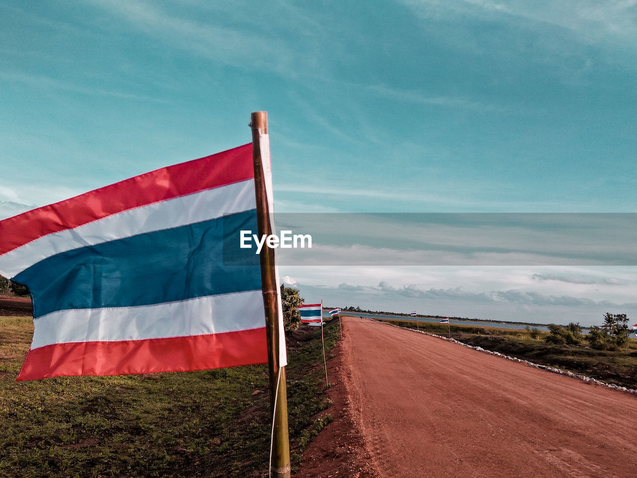 Thai flag on land against sky