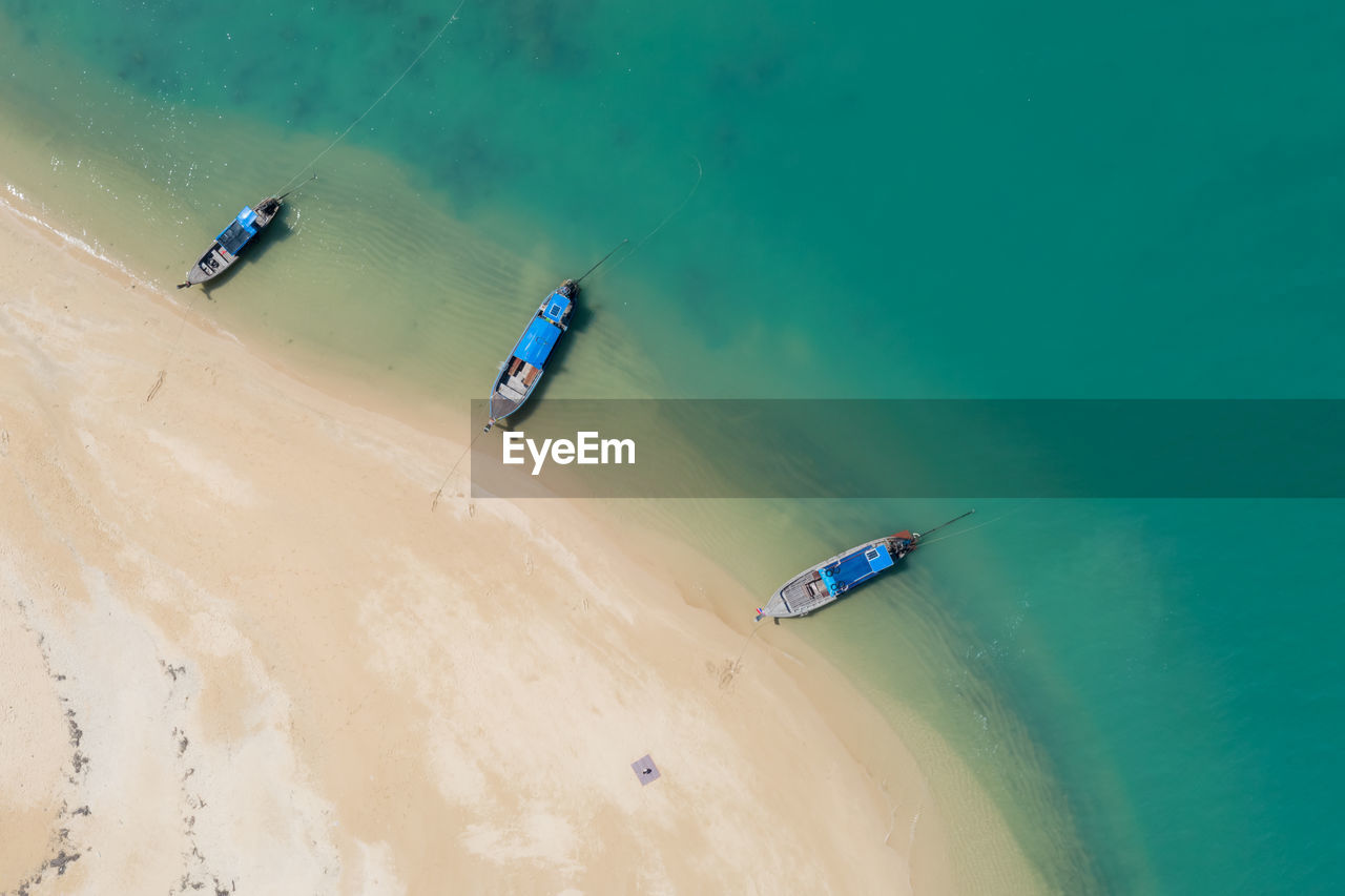 Long tail boat on the sand beach in island kra bi thailand aerial view