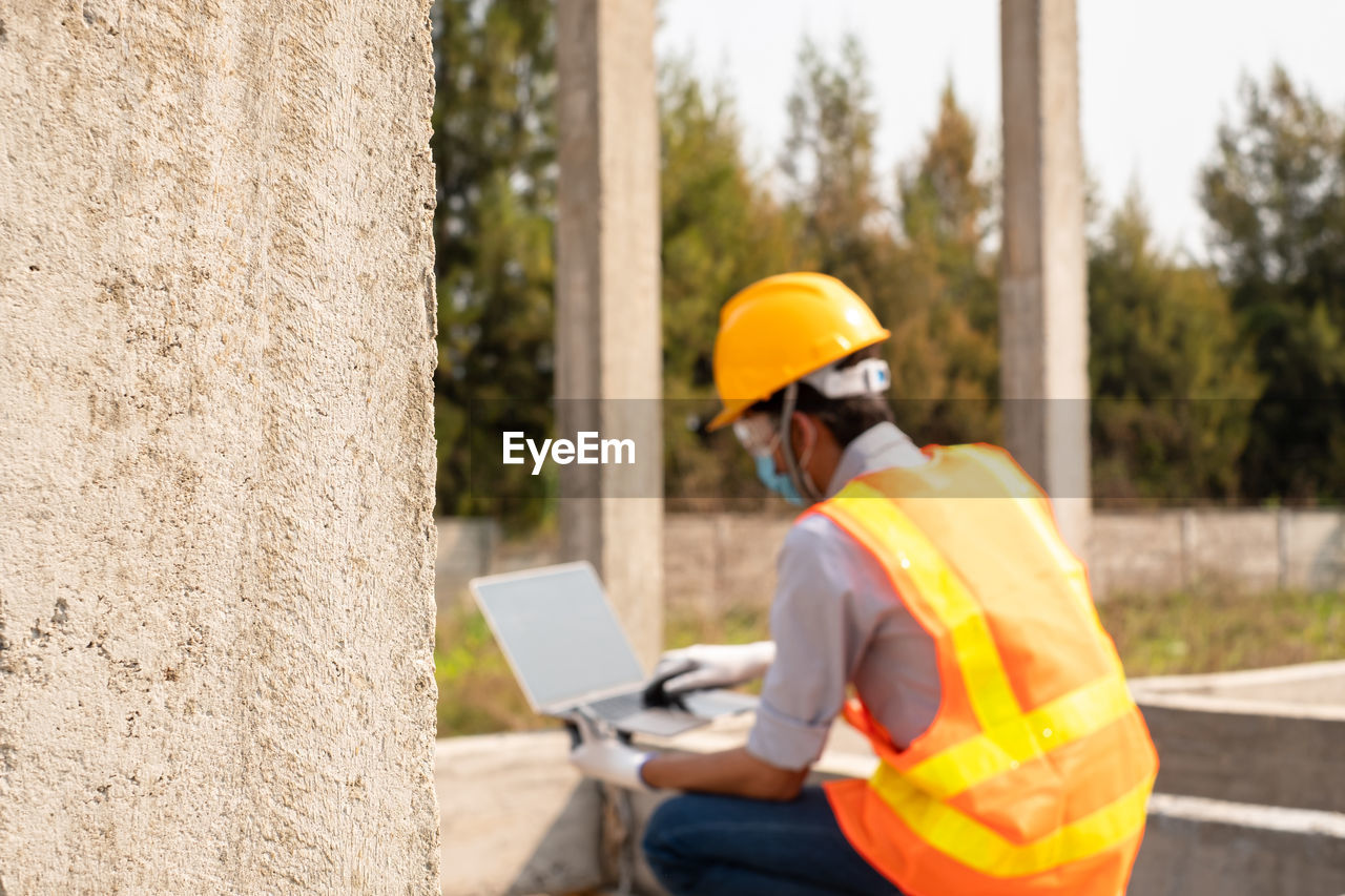 rear view of man working at construction site
