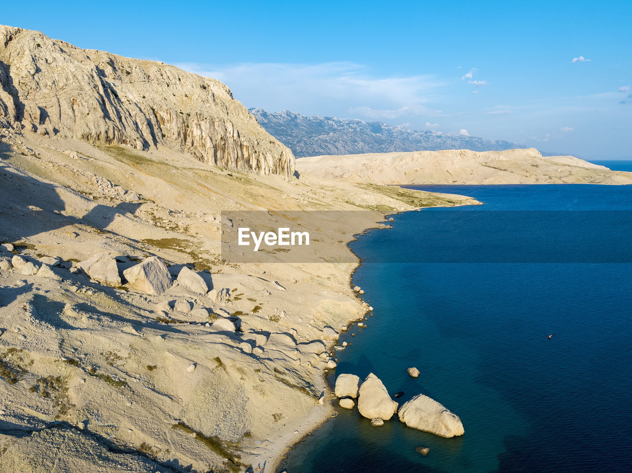 Scenic view of rocks in sea against sky