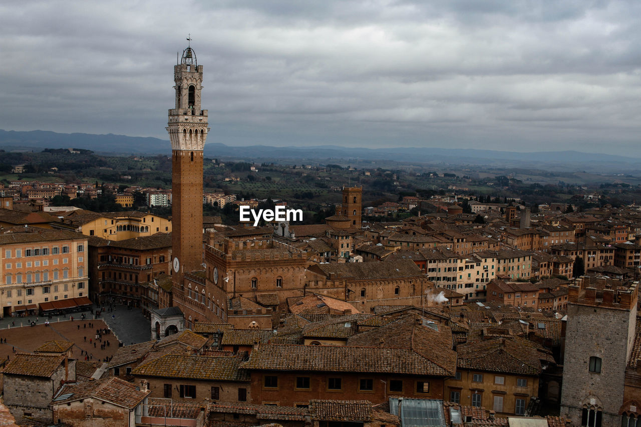 Siena italy ,buildings in city against cloudy sky