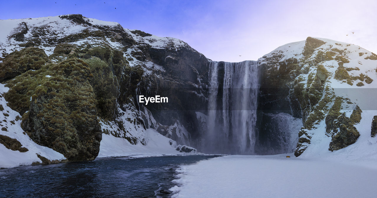 Beautiful scenery of the majestic Skogafoss Waterfall in countryside of Iceland in winter. Skogafoss waterfall is the top famous natural landmark and tourist destination place of Iceland and Europe. Travel Iceland Waterfall Nature Landscape Skogafoss View Landmark Icelandic Water Adventure Mountain Scenic Popular Sky Tourism River Outdoor Cliff Blue Wanderlust Natural Famous Green Beautiful Rainbow Tourist Amazing Island Destination Stream Background Cascade Photography Panorama Vacation Beauty Wilderness Breathtaking BIG