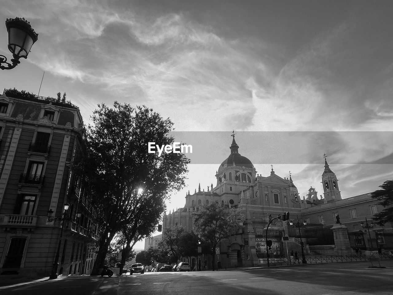 Black and white photo of the la almudena cathedral in madrid, with clouds