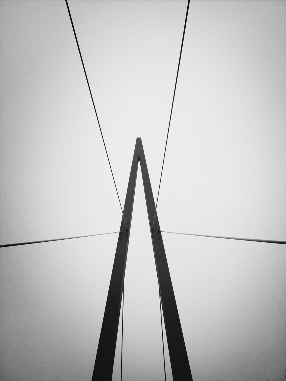 Low angle view of suspension bridge against clear sky