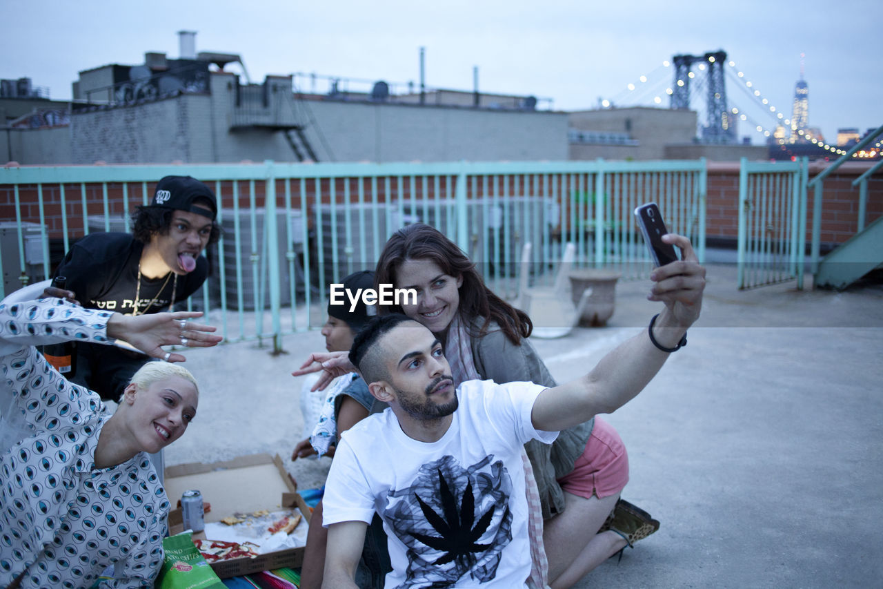 Friends hanging out on a building rooftop