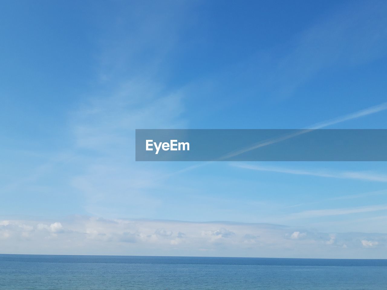 Scenic view of sea against blue sky