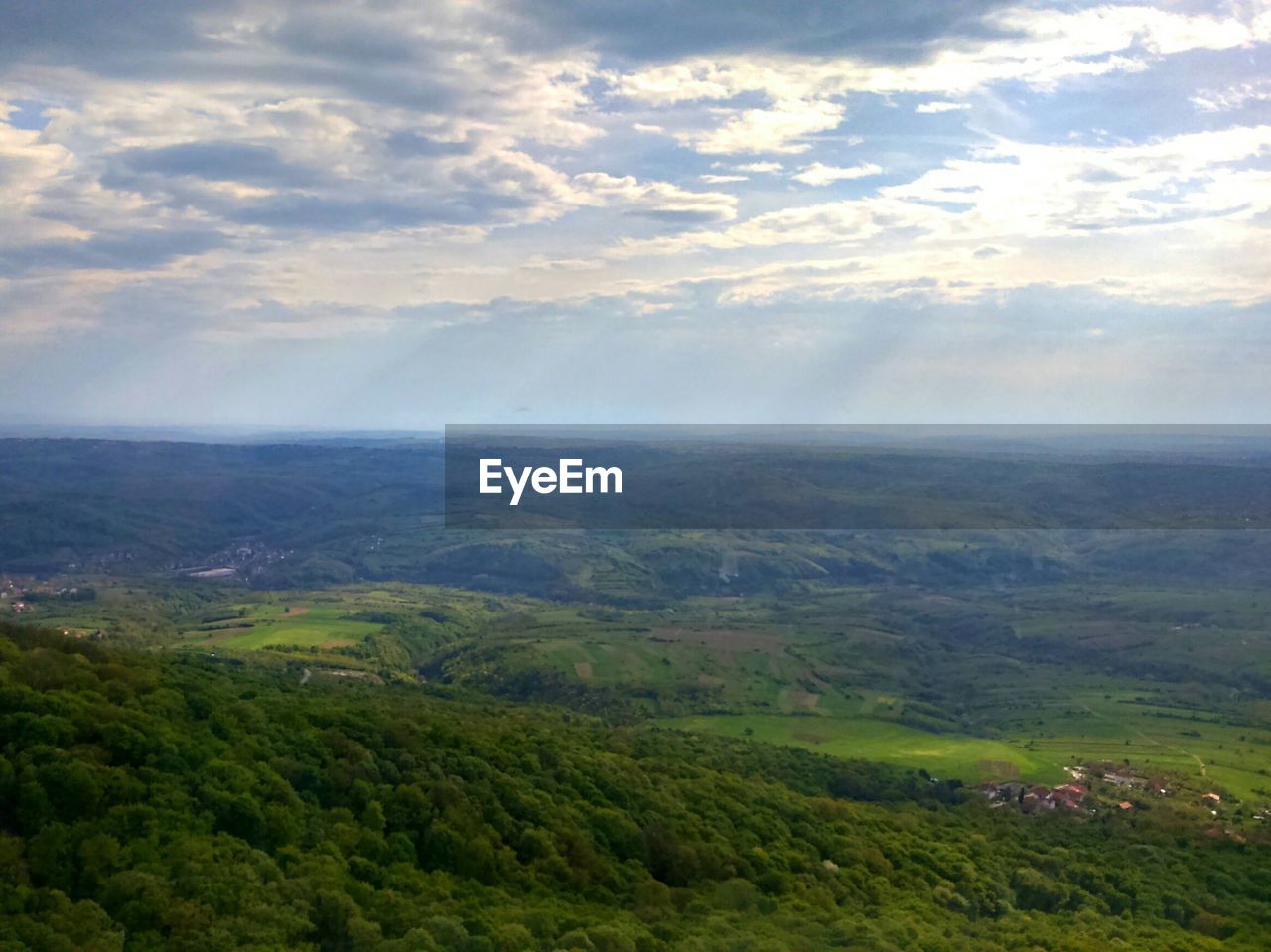 High angle view of green landscapes on sunny day