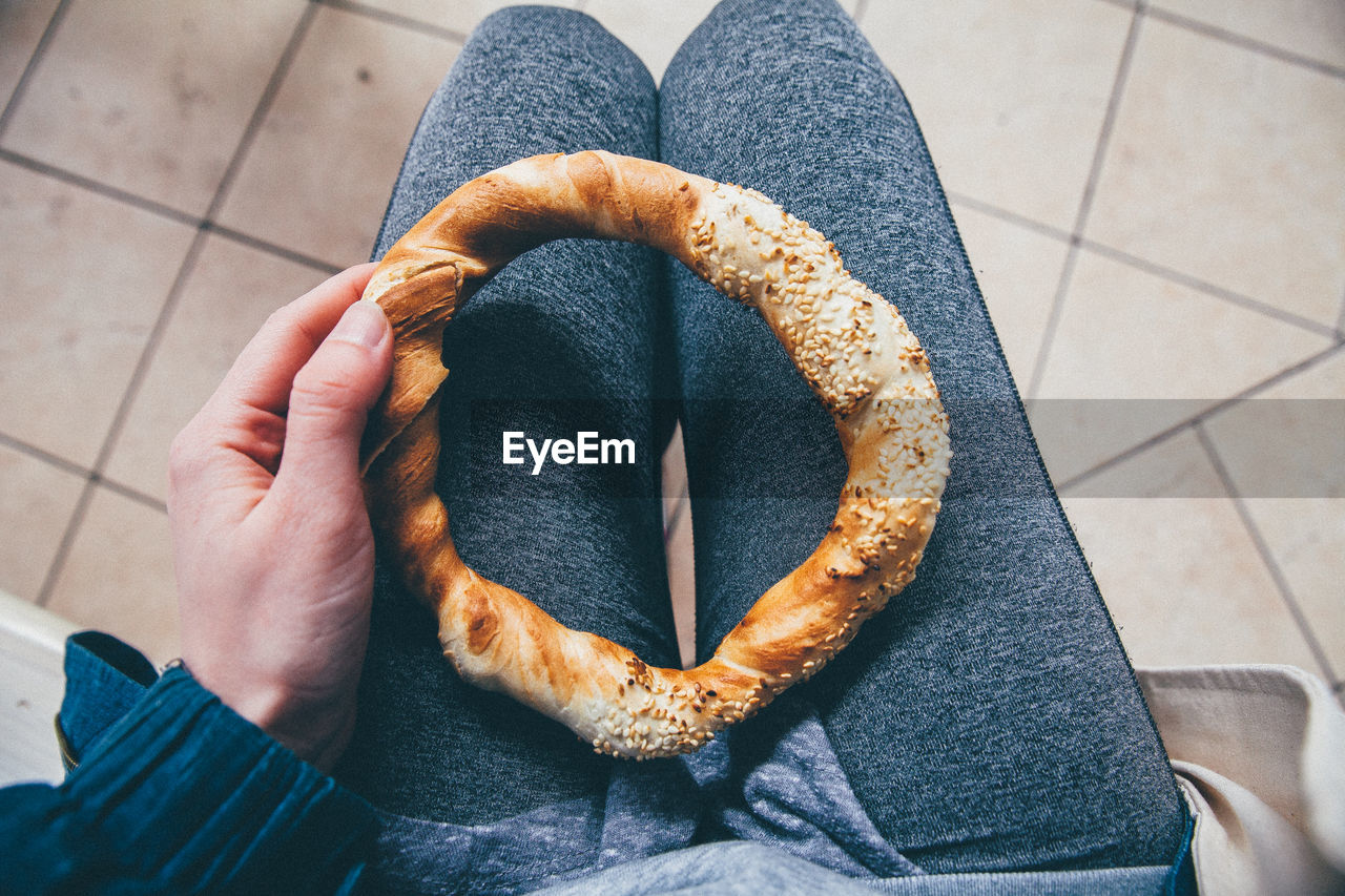 Mid section of a woman holding pretzel