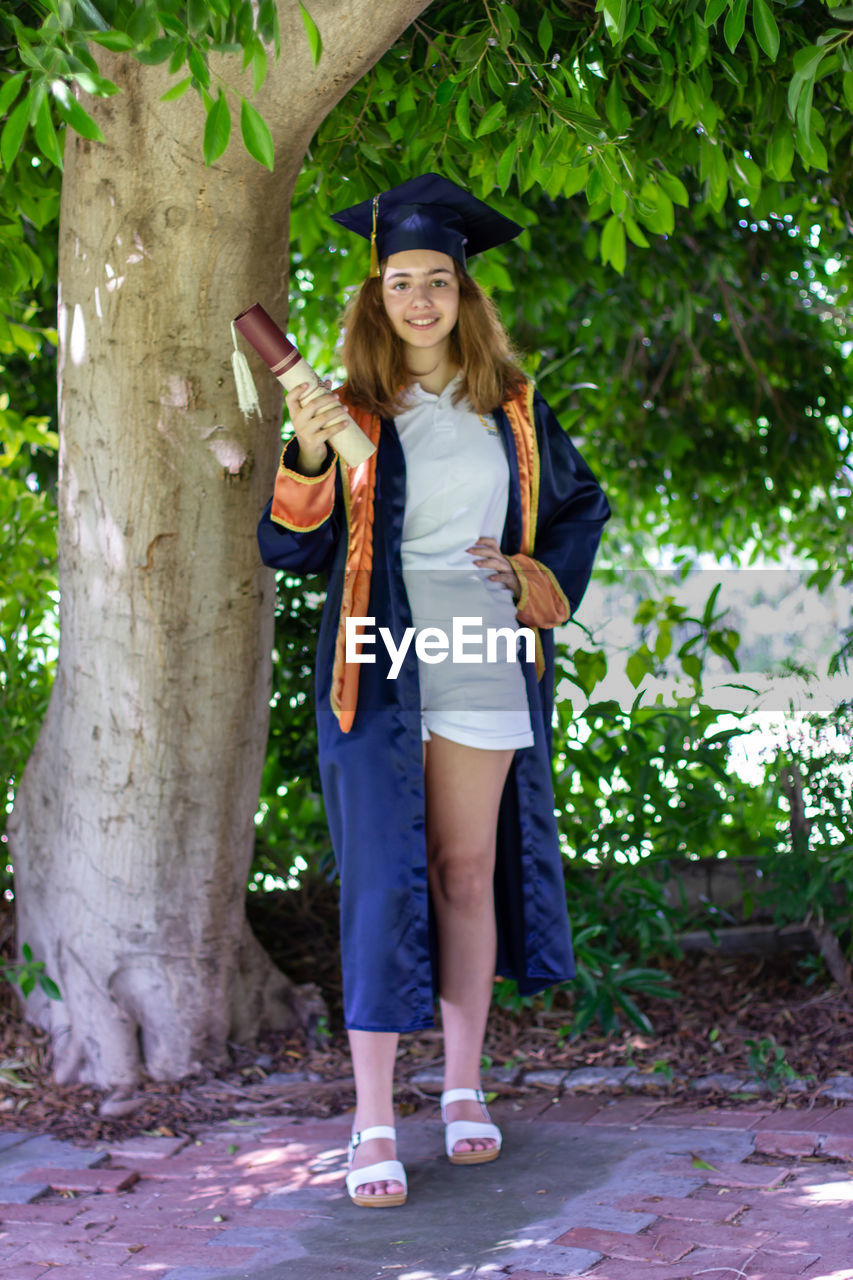 High school graduate. schoolgirl in graduation cap and mantle.