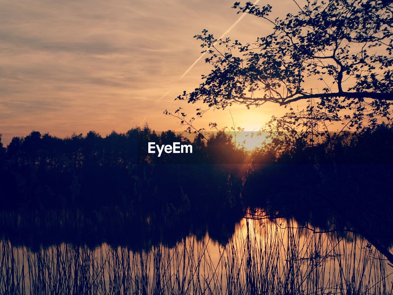 SCENIC VIEW OF LAKE AGAINST ORANGE SKY