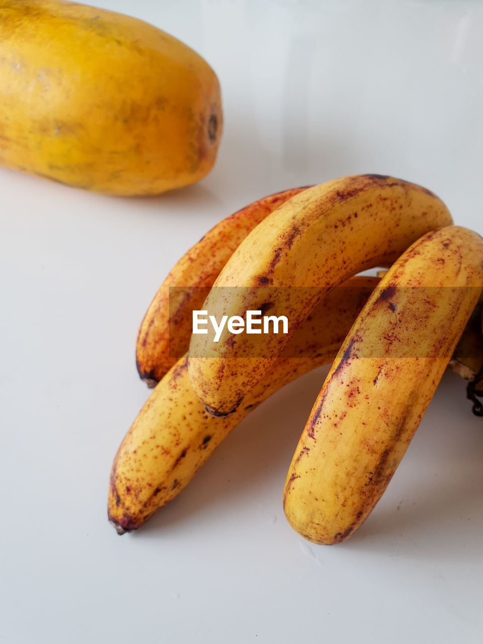 Close-up of babanas fruits  on table against white background