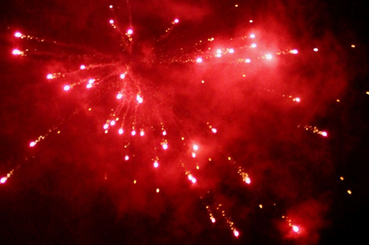 Low angle view of firework display at night