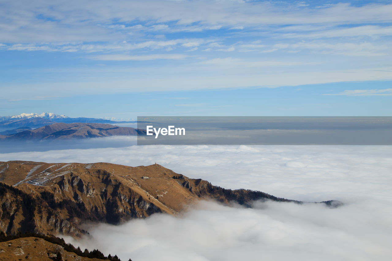 Scenic view of mountains against sky in foggy weather